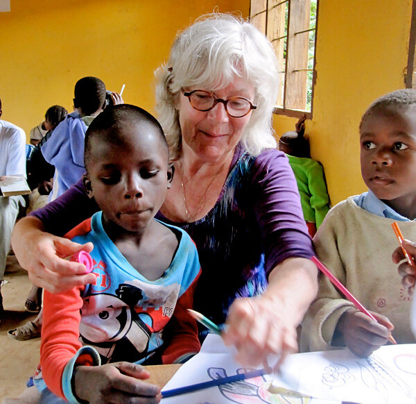 A Projects Abroad volunteer helps children with an educational activity at a Care project
